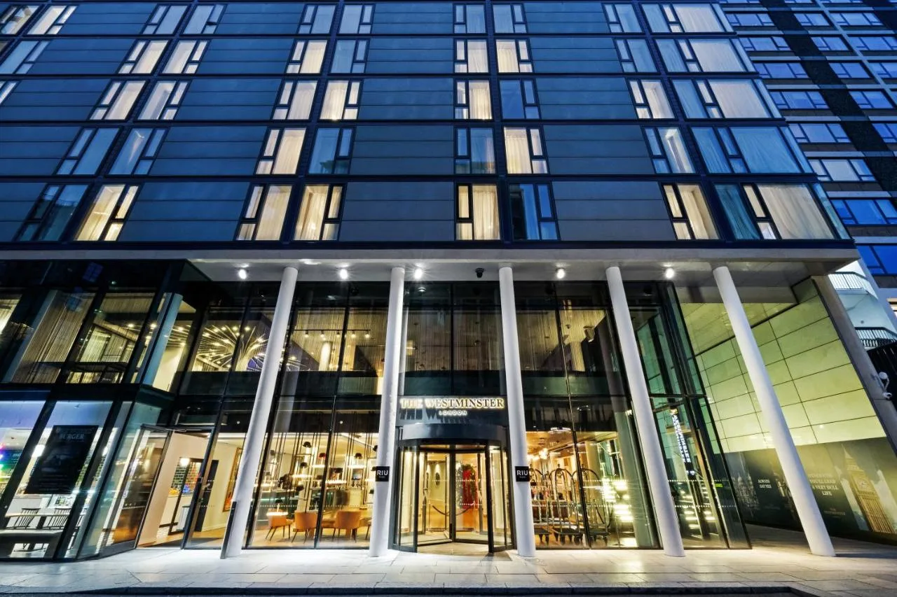 Tall glass building with a revolving door at Riu Plaza Westminster in London